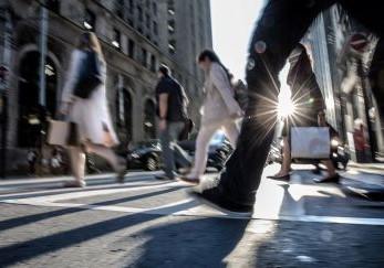 Pedestrians crossing a city intersection.