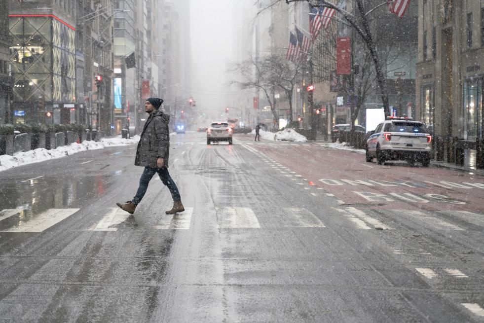 pedestrian crossing a rainy street 